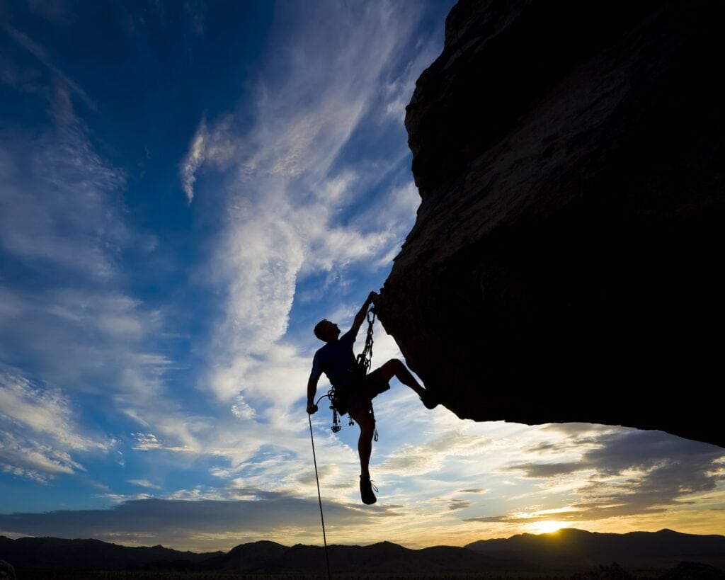 the climb tv series guy hanging on the rock