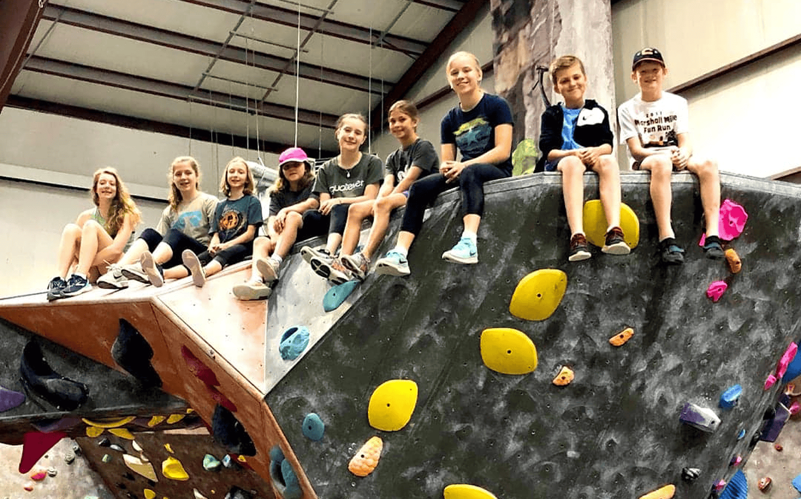 Kids climbing together during a rock climbing birthday party at Vertical Rock